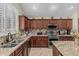 Charming kitchen featuring granite countertops, stainless steel appliances, and custom cabinetry at 26249 N 68Th Ln, Peoria, AZ 85383