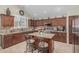 Modern kitchen with dark wood cabinets, granite countertops, and stainless steel appliances at 26249 N 68Th Ln, Peoria, AZ 85383