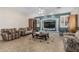 Comfortable living room featuring tile floors, a decorative fireplace, and a ceiling fan at 26249 N 68Th Ln, Peoria, AZ 85383