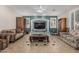 Cozy living room showcasing a decorative fireplace, tiled flooring, and neutral colors at 26249 N 68Th Ln, Peoria, AZ 85383