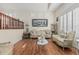 Elegant living room featuring hardwood floors, plantation shutters, and designer furnishings at 26249 N 68Th Ln, Peoria, AZ 85383