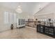 Open living room featuring a crystal chandelier, neutral walls, and shuttered windows at 26249 N 68Th Ln, Peoria, AZ 85383