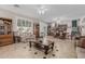 Spacious living room with tile flooring, neutral walls, and multiple seating areas at 26249 N 68Th Ln, Peoria, AZ 85383