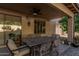 Covered patio with a dining table set, tiled flooring and a ceiling fan overhead at 26249 N 68Th Ln, Peoria, AZ 85383