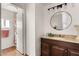 Bathroom featuring a wood vanity with granite counters, with a shower visible through the open door at 2650 W Union Hills Dr # 100, Phoenix, AZ 85027