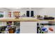 Kitchen featuring butcher block countertop with white cabinets and organized open shelving at 2650 W Union Hills Dr # 100, Phoenix, AZ 85027