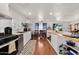 Open-concept kitchen with island, stainless steel appliances, and view to dining area at 2650 W Union Hills Dr # 100, Phoenix, AZ 85027