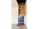 An attic pull-down ladder is ready to extend from the ceiling above a door and a mat on the floor at 2749 S Rita Ln, Tempe, AZ 85282