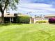 Lush, grassy backyard with mature trees and desert plants at 2749 S Rita Ln, Tempe, AZ 85282