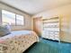 Bright bedroom with a twin bed, built-in storage and plush teal carpeting at 2749 S Rita Ln, Tempe, AZ 85282