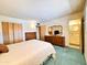 A cozy bedroom boasts wood-toned furniture and an attached bath at 2749 S Rita Ln, Tempe, AZ 85282