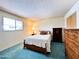 Bright bedroom with blue carpet, window, and furniture at 2749 S Rita Ln, Tempe, AZ 85282