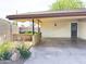 Attached carport featuring painted walls, a rear entry door, and decorative landscaping at 2749 S Rita Ln, Tempe, AZ 85282