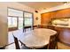 Comfortable dining area with a marble-top table, wooden chairs, and a sliding glass door to a patio at 2749 S Rita Ln, Tempe, AZ 85282