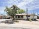 Charming single-story home featuring a mature tree, low brick wall, carport, and desert landscaping at 2749 S Rita Ln, Tempe, AZ 85282