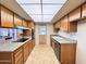 Bright kitchen featuring tile flooring, stone countertops, wood cabinets and modern appliances at 2749 S Rita Ln, Tempe, AZ 85282