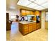 Kitchen with wood cabinets, neutral countertops, and a breakfast bar open to the living spaces at 2749 S Rita Ln, Tempe, AZ 85282