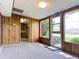 Cozy living room with wood paneling and large windows, leading to the backyard at 2749 S Rita Ln, Tempe, AZ 85282