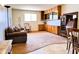 Bright living room featuring built-in cabinets, a rocking chair, and a large window at 2749 S Rita Ln, Tempe, AZ 85282