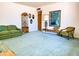 Bright living room features blue carpeting, a display cabinet, a painting, and comfortable seating at 2749 S Rita Ln, Tempe, AZ 85282