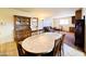 Open-concept space with dining area and living room featuring a sofa, hutch, and a marble-top table at 2749 S Rita Ln, Tempe, AZ 85282