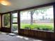Bright sunroom with large windows offering views of the lush landscaping and neighborhood at 2749 S Rita Ln, Tempe, AZ 85282
