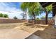 A spacious backyard with gravel, a concrete patio, and mature trees overhead at 2914 W Marlette Ave, Phoenix, AZ 85017