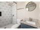 Stylishly updated bathroom featuring granite counters, geometric tile shower, and modern fixtures at 2914 W Marlette Ave, Phoenix, AZ 85017