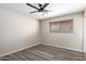 Bright bedroom with fan, window with wood blinds, and wood-look vinyl plank flooring at 2914 W Marlette Ave, Phoenix, AZ 85017