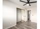 Bedroom with sliding door closet, overhead fan, and wood-look vinyl plank flooring at 2914 W Marlette Ave, Phoenix, AZ 85017