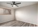 A bright bedroom featuring modern gray vinyl floors and a ceiling fan at 2914 W Marlette Ave, Phoenix, AZ 85017