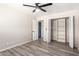 Bedroom featuring fan, closet with shelves, and stylish plank flooring at 2914 W Marlette Ave, Phoenix, AZ 85017