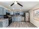 Modern kitchen features blue cabinets, stainless steel appliances, stylish backsplash, and durable flooring at 2914 W Marlette Ave, Phoenix, AZ 85017
