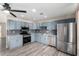 Bright kitchen boasts stainless steel appliances, grey backsplash, granite counters, and wood-look floors at 2914 W Marlette Ave, Phoenix, AZ 85017