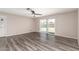 Spacious living room featuring wood-look floors, ceiling fan, and sliding glass door leading to the backyard at 2914 W Marlette Ave, Phoenix, AZ 85017