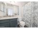 Bathroom featuring a granite countertop vanity, large mirror, and a patterned shower curtain at 31227 N 45Th St, Cave Creek, AZ 85331