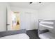 Bright bedroom featuring bunk beds, a sliding-door closet, and gray carpet flooring at 31227 N 45Th St, Cave Creek, AZ 85331