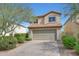 Charming two-story home featuring a large garage, desert landscaping, and a classic tile roof at 31227 N 45Th St, Cave Creek, AZ 85331