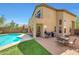 Backyard featuring a freeform pool, a patio, lounge seating, and green lawn at 31227 N 45Th St, Cave Creek, AZ 85331