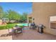 Outdoor patio featuring a dining table set, barbecue grill, green grass and pool at 31227 N 45Th St, Cave Creek, AZ 85331