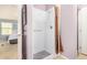 Bathroom featuring a white shower, purple walls, grey mat and partial view of bedroom at 33852 N 52Nd St, Cave Creek, AZ 85331
