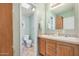 Bathroom with green walls featuring double sinks, wooden cabinets, and a toilet at 33852 N 52Nd St, Cave Creek, AZ 85331