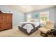 Bedroom featuring carpet, a large bed, natural light from multiple windows and a cozy chair at 33852 N 52Nd St, Cave Creek, AZ 85331