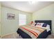 Bedroom with green walls featuring a bed with a patterned blanket and natural lighting at 33852 N 52Nd St, Cave Creek, AZ 85331