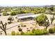 Aerial view of home showcasing covered patio, mature landscaping, and desert setting at 33852 N 52Nd St, Cave Creek, AZ 85331
