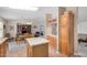 Open-concept kitchen with island, cabinets, and view into dining area with hardwood floors at 33852 N 52Nd St, Cave Creek, AZ 85331