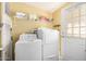 Laundry room with a washer, dryer, white cabinets and a yellow wall at 33852 N 52Nd St, Cave Creek, AZ 85331