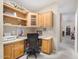 Office space featuring wooden desk with cabinets, overhead shelving, and a comfortable chair at 33852 N 52Nd St, Cave Creek, AZ 85331