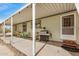 Covered patio area with table, chairs, grill, and door to the exterior at 33852 N 52Nd St, Cave Creek, AZ 85331