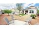 Desert landscaped backyard with covered patio and outdoor seating at 3402 N 300Th Dr, Buckeye, AZ 85396